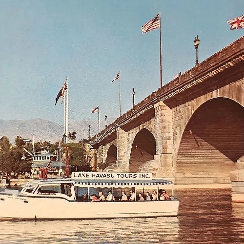 Old image of Ferry Boat full of tourist passing under the bridge of Lake Havasu