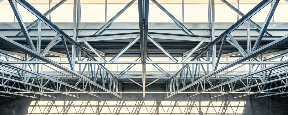 Clean, symmetrical industrial warehouse interior shot with strong geometric shadow patterns and aspirational tone?technically sound and ready for use as real es