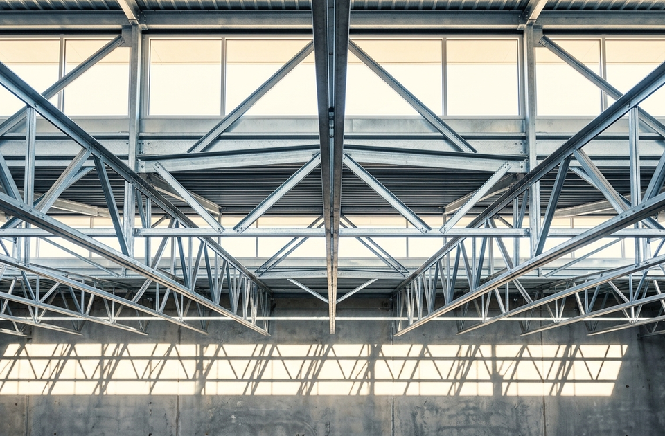 Clean, symmetrical industrial warehouse interior shot with strong geometric shadow patterns and aspirational tone?technically sound and ready for use as real es